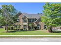 Stately brick home with well-manicured lawn, mature trees and inviting curb appeal at 4765 Smokestone Dr, Douglasville, GA 30135