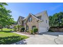 Spacious home with a brick facade, two-car garage, and a lovely green lawn at 4765 Smokestone Dr, Douglasville, GA 30135