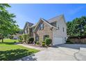 Well-maintained home with brick and siding, attached garage, and a beautifully landscaped yard at 4765 Smokestone Dr, Douglasville, GA 30135