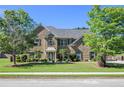Brick home with lush landscaping, palm trees, and mature shade trees at 4765 Smokestone Dr, Douglasville, GA 30135