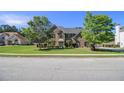 Beautiful two-story brick home with a well-manicured lawn and mature trees at 4765 Smokestone Dr, Douglasville, GA 30135