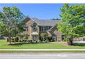 Charming two-story brick home with lush landscaping and a manicured lawn at 4765 Smokestone Dr, Douglasville, GA 30135