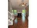 Spacious living room with hardwood floors, fireplace, and access to the backyard at 615 Amberwood Pl, Euharlee, GA 30145