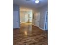 Open floor plan featuring hardwood floors and natural light, leading to the kitchen at 1651 Massachusetts Sw Ave # 1, Marietta, GA 30008