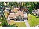 Aerial view of a charming home with a spacious backyard, partially fenced, complemented by an open deck at 3050 Woodland Nw Dr, Kennesaw, GA 30152
