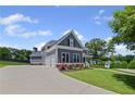 Two-story home with a spacious driveway, attached garage, and well-maintained lawn with mature trees at 4035 Pinebrook Cir, Cumming, GA 30028