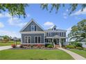 Attractive two-story home with a well-manicured lawn and lovely landscaping under a bright sky at 4035 Pinebrook Cir, Cumming, GA 30028