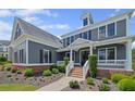 Beautiful two-story home with a brick foundation, landscaped yard, and inviting front porch at 4035 Pinebrook Cir, Cumming, GA 30028