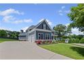 Attractive two-story home featuring a long driveway, a three-car garage, and manicured landscaping at 4035 Pinebrook Cir, Cumming, GA 30028