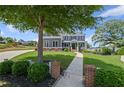 Beautiful two-story home with mature landscaping, walkway, manicured lawn and inviting curb appeal at 4035 Pinebrook Cir, Cumming, GA 30028
