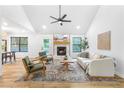 Bright living room with a fireplace, vaulted ceilings, modern furnishings, and large windows at 1105 Sallete Ct, Marietta, GA 30066