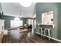 Inviting living room boasts hardwood floors, a fireplace, and a breakfast bar open to a modern, white kitchen at 2204 Dresden Nw Grn, Kennesaw, GA 30144