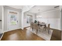 Formal dining room with wainscoting, hardwood floors, modern chandelier, and seating for six at 4093 Groveland Park Dr, Powder Springs, GA 30127