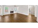 Spacious living room with wood floors, fireplace and view into a bathroom at 4093 Groveland Park Dr, Powder Springs, GA 30127