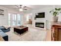 Cozy living room featuring a fireplace, a brown ottoman, and glass pane doors to deck at 1445 Monroe Ne Dr # F18, Atlanta, GA 30324