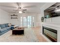 Comfortable living room offers backyard access via glass pane doors and features a fireplace at 1445 Monroe Ne Dr # F18, Atlanta, GA 30324