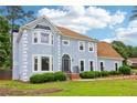 Light blue two-story home with a well-kept lawn on a sunny day at 771 James Cir, Lawrenceville, GA 30046
