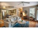 Open concept living room into kitchen with hardwood floors and lots of light at 1025 Mcgill Park Ne Ave, Atlanta, GA 30312