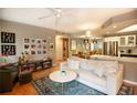 An open-concept living room with hardwood floors, neutral colors, and lots of seating at 1025 Mcgill Park Ne Ave, Atlanta, GA 30312