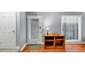 Bright entryway featuring hardwood floors, a storage cabinet, and a storm door at 2682 Arbor Glen Pl., Marietta, GA 30066