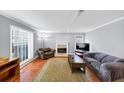 Comfortable living room featuring a fireplace, plush seating, and natural light from windows at 2682 Arbor Glen Pl., Marietta, GA 30066