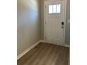 Entryway with a white door and sidelight on wood-look flooring at 3708 Cheswolde Ave, Powder Springs, GA 30127