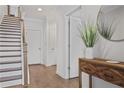 Inviting entryway with hardwood floors, staircase, console table and decorative mirror at 820 Kenway Ave, Roswell, GA 30076