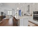 Bright, open kitchen featuring a large island, stainless steel appliances, and stylish pendant lighting at 820 Kenway Ave, Roswell, GA 30076