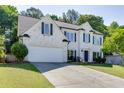 Beautiful two-story brick home with a well-maintained lawn and a long concrete driveway at 1755 Waters Ferry Dr, Lawrenceville, GA 30043