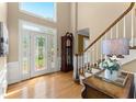 Bright foyer with hardwood floors, decorative front door and sidelights, and elegant staircase at 2841 Landing Dr, Marietta, GA 30066