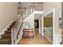 Inviting foyer with hardwood floors, staircase, and view into adjacent room filled with natural light at 2841 Landing Dr, Marietta, GA 30066