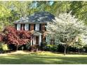 Traditional brick home with mature trees and a well-manicured lawn at 3625 Stonehenge Ne Way, Marietta, GA 30066