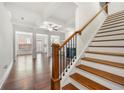 Open-concept living area features hardwood floors, fireplace, and elegant staircase at 5365 Radford Loop, Fairburn, GA 30213