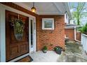 Charming front entrance featuring a wooden door with wreath and brick surround at 8555 Hope Mews Ct, Sandy Springs, GA 30350
