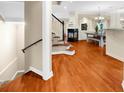 Open-concept living space with beautiful hardwood floors and staircase at 8555 Hope Mews Ct, Sandy Springs, GA 30350