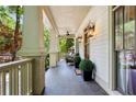 Inviting porch with dark wood floors, sconce lighting, and neutral exterior paint at 1014 Seaboard Nw Ave, Atlanta, GA 30318
