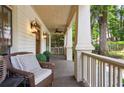 Relaxing front porch with classic columns, ceiling fan and stylish outdoor furnishings at 1014 Seaboard Nw Ave, Atlanta, GA 30318