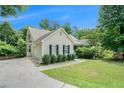 Side view of a one-story home with a garage and well-kept landscaping at 1211 Fly Rod Ln, Loganville, GA 30052