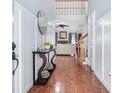 Inviting foyer with hardwood floors and a view of the living room and staircase at 1211 Fly Rod Ln, Loganville, GA 30052