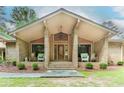 Inviting front porch with brick accents, steps, and rocking chairs, leading to an attractive front door at 2228 Walker Dr, Lawrenceville, GA 30043