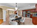 Eat-in kitchen features stainless steel appliances, granite counters, tile flooring, and a view to the living room at 2279 Parkview Cir, College Park, GA 30337