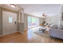 Bright living room featuring hardwood floors, a large window, and a stylish entrance door at 2279 Parkview Cir, College Park, GA 30337