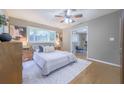 Cozy bedroom with a ceiling fan, natural light, and access to an additional room at 2279 Parkview Cir, College Park, GA 30337