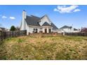 Expansive backyard featuring a well-maintained lawn, brick patio, and secure fencing at 2738 Lakewater Way, Snellville, GA 30039