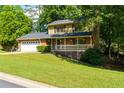 Charming two-story home boasts a brick front, attached garage, a welcoming porch, and a beautifully landscaped yard at 28 Indian Branch Way, Lawrenceville, GA 30043