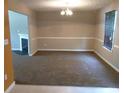 Inviting dining room with warm neutral tones, carpeted floor, and window with blinds for a cozy dining experience at 4368 Rocky View Dr, Forest Park, GA 30297
