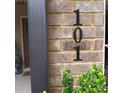 Close-up of the house number '101' on a brick exterior with some greenery in view at 101 Dewey Rd, Lilburn, GA 30047