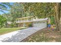 Charming two-story home with a brick facade, upper porch, long driveway, and a two-car garage at 1080 Northshore Dr, Roswell, GA 30076