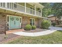 Inviting front entrance with a double door, brick facade, and mature landscaping at 1080 Northshore Dr, Roswell, GA 30076