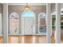 Bright foyer featuring hardwood floors, arched windows, and decorative columns create an elegant entrance at 1420 Arblay Pl, Loganville, GA 30052
